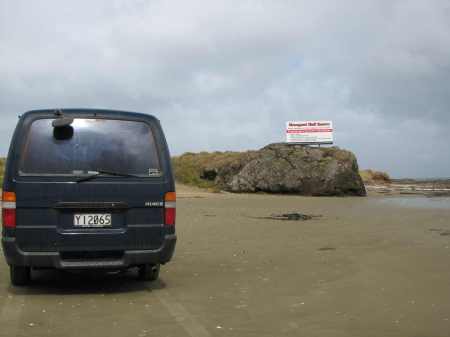 My van in front of "The Bluff" on 90-Mile beach.  The Bluff is the only rocky feature the entire 66-mile length of the beach and it is the tidal "pinch point", meaning that as the tide rises this is the toughest place to get around whether you are headed north or south.  At mid-tide the waves begin a wash up to the rocks of the Bluff.