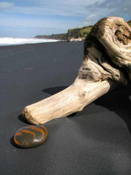 Polished black sand and a nice tiger-striped rock on the nothern Waverley Beach..