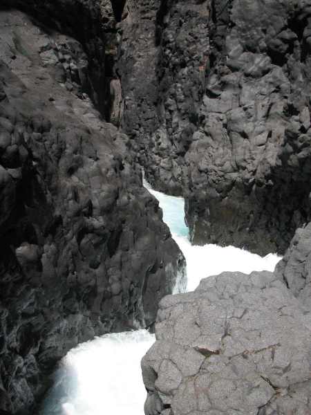 The water-worn black basalt framing the entrance of Tree Trunk Gorge.